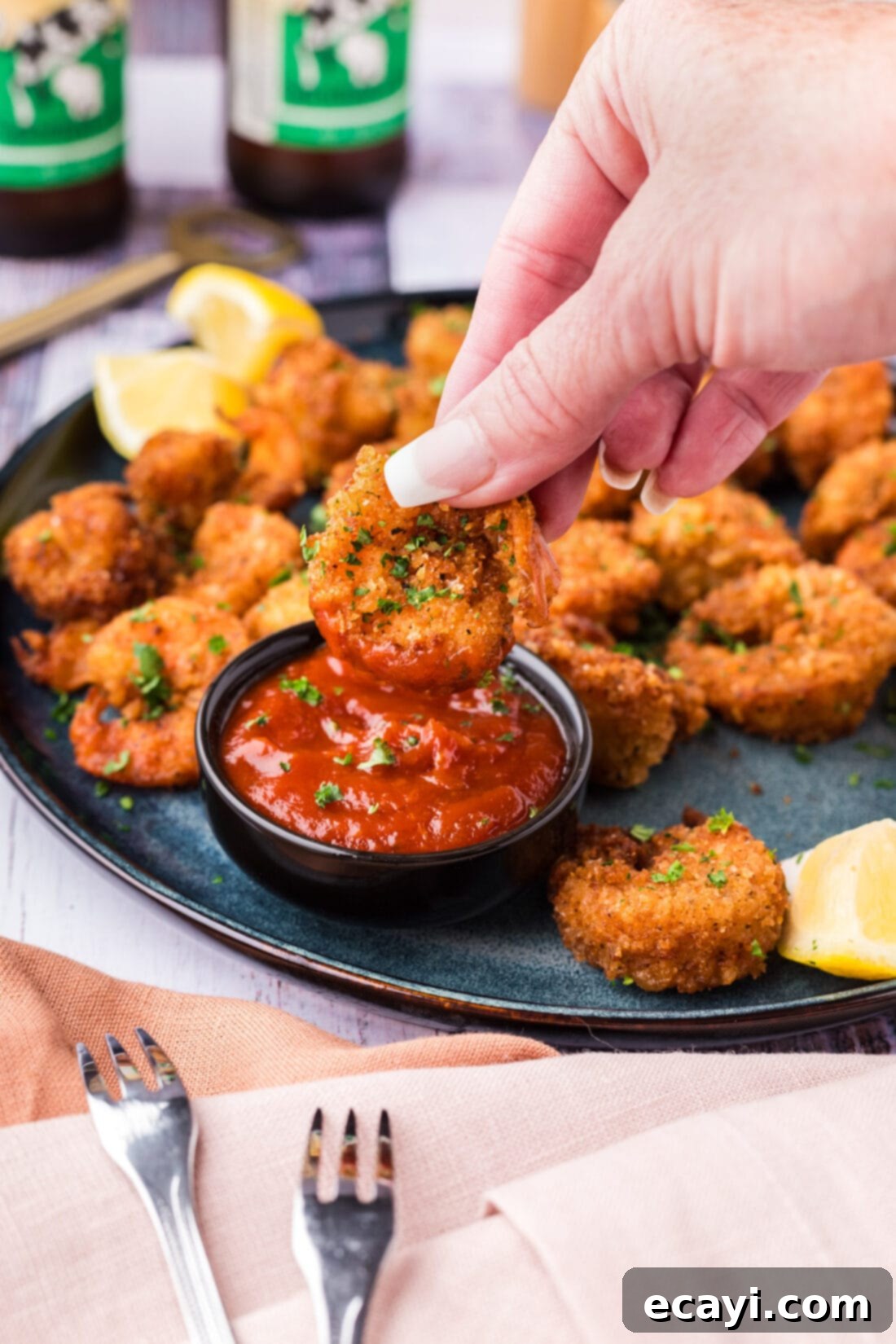 Crispy Fried Shrimp 14 Breaded Shrimp being dipped in cocktail sauce