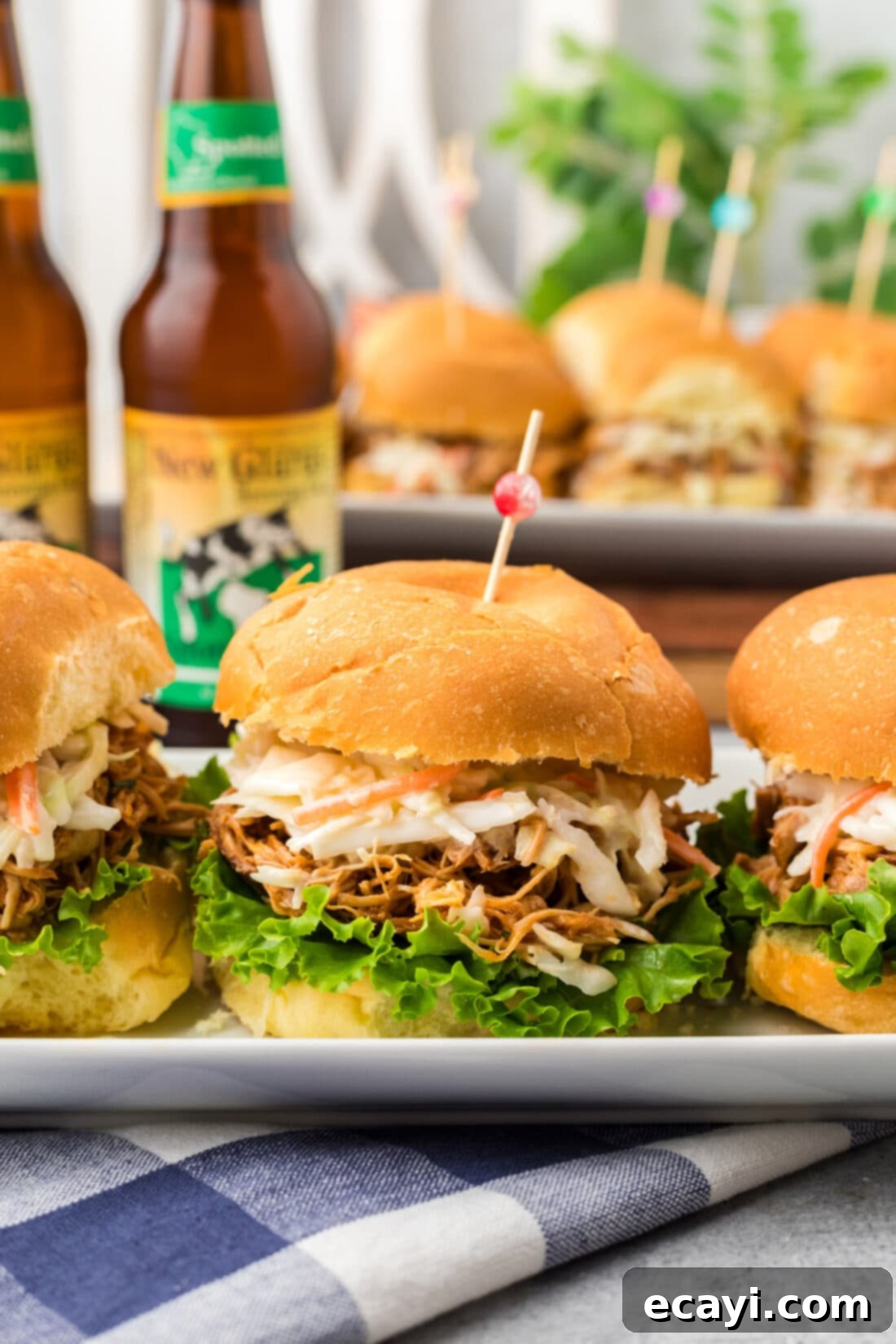 Smoky BBQ Chicken Sandwich 3 Close up photo of a perfectly assembled BBQ Chicken Sandwich with shredded chicken, coleslaw, and lettuce.