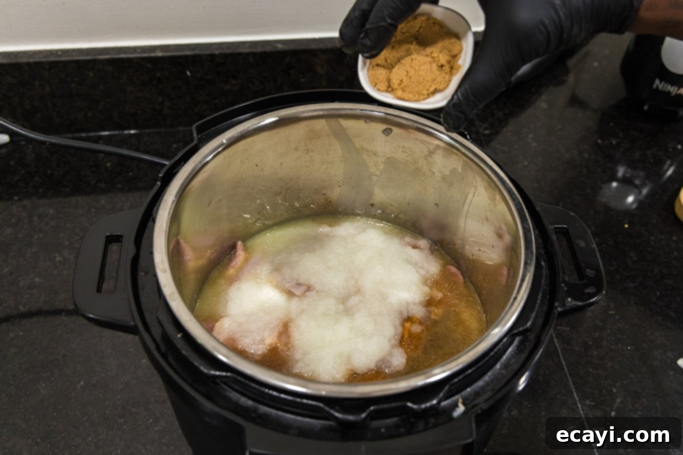 Smoky BBQ Chicken Sandwich 9 Sprinkling brown sugar over the chicken and minced onion in the Instant Pot.