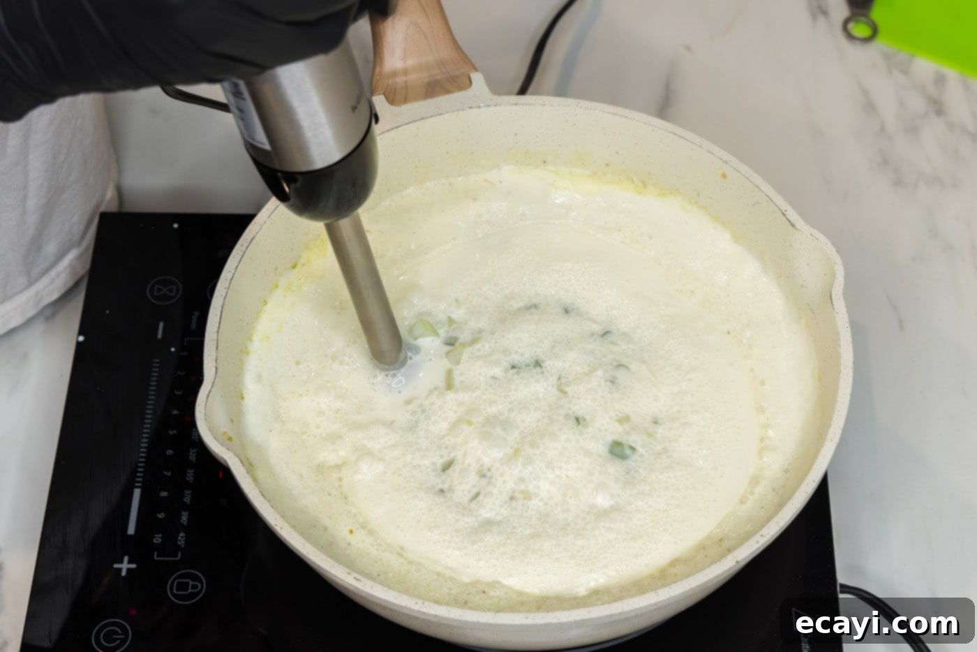 Decadent Lobster Pasta 15 using an immersion blender to break up chunks in pasta sauce