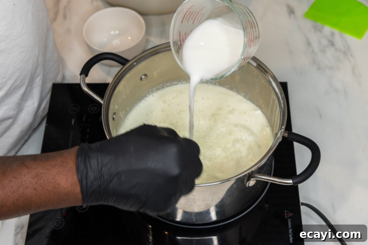 Decadent Lobster Pasta 18 whisking cornstarch slurry into sauce in a pot