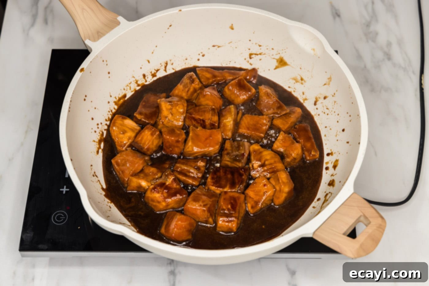 Salmon Morsels 12 Cooking salmon bites in the honey soy marinade in a skillet, creating a delicious glaze.