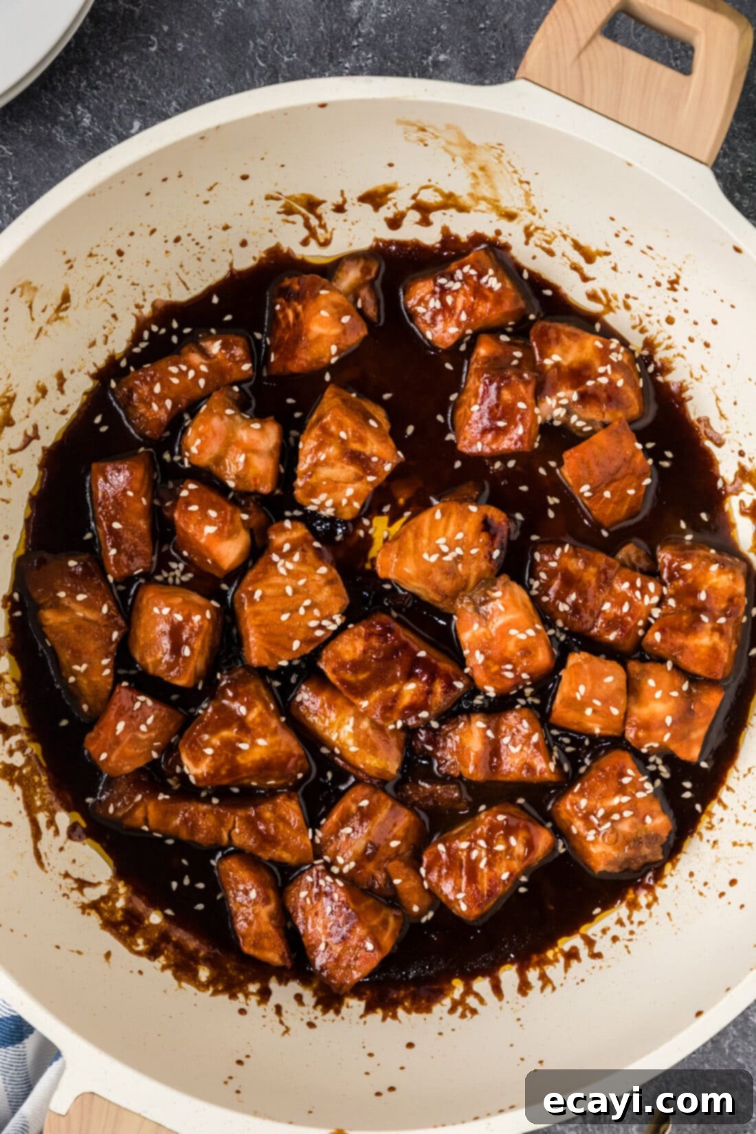 Salmon Morsels 13 Close-up of perfectly glazed and crispy Honey Soy Salmon Bites simmering in a skillet, showcasing the rich sauce.