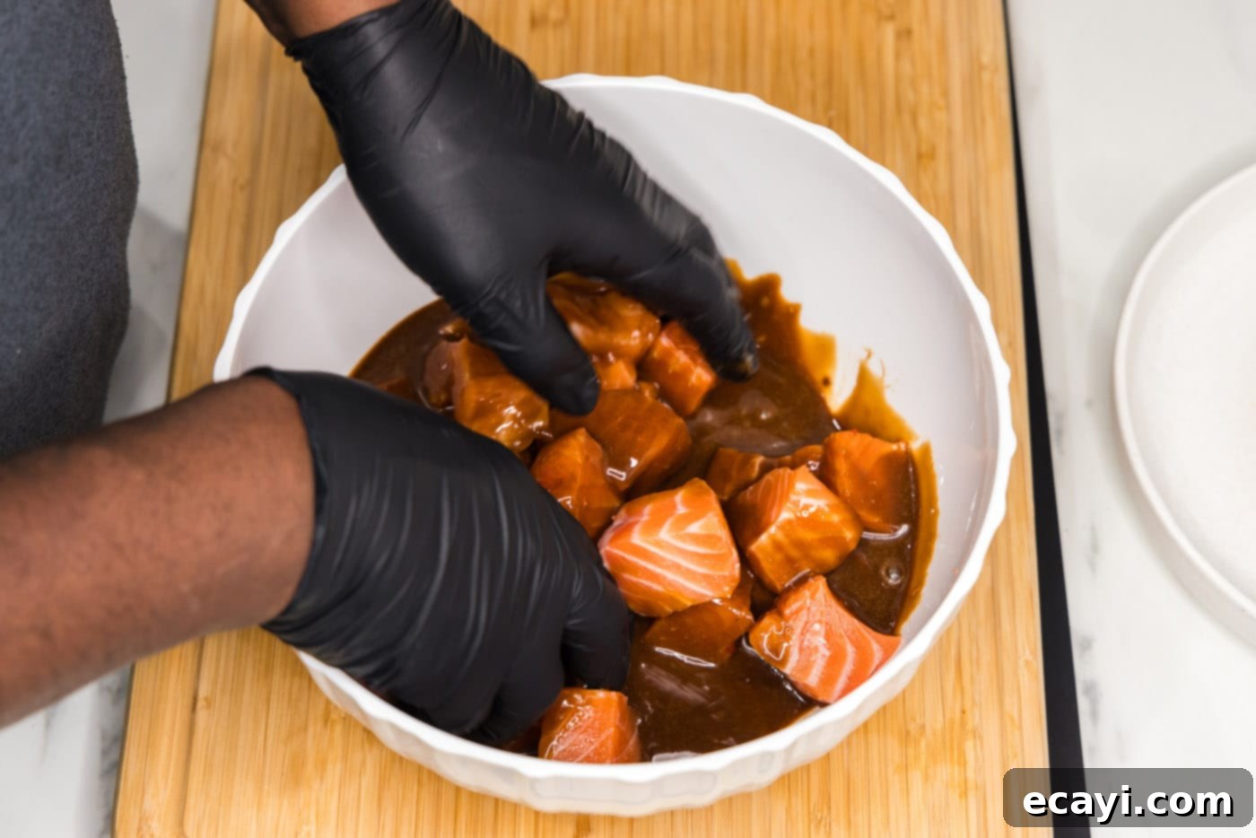 Salmon Morsels 9 Gently tossing salmon bites in the honey soy sauce marinade to ensure even coating.