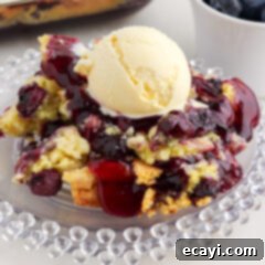 Effortless Blueberry Delight 10 Blueberry Dump Cake on a plate topped with a scoop of ice cream