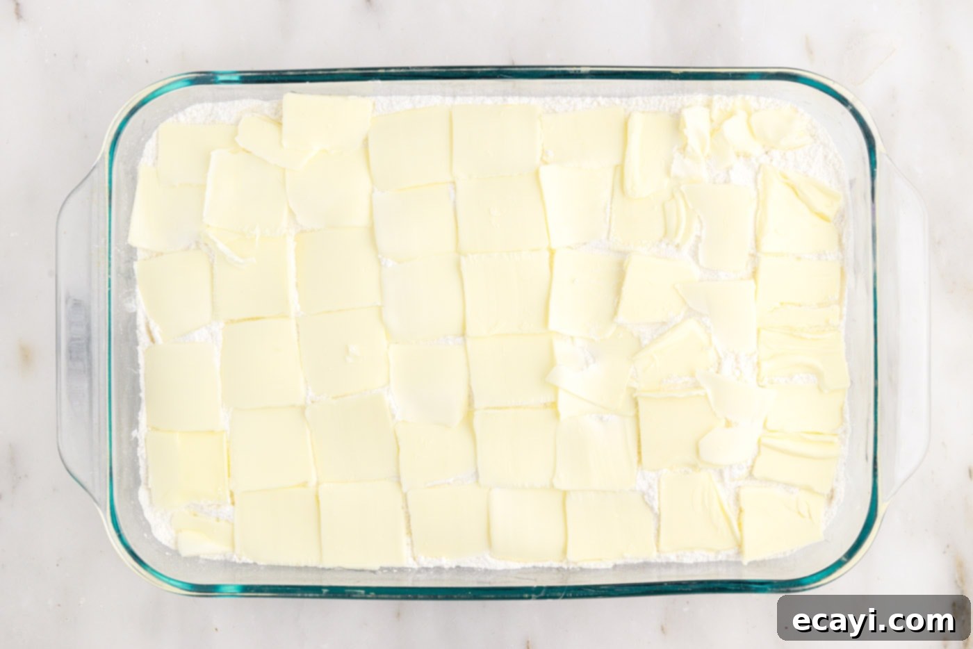 Effortless Blueberry Delight 6 pats of butter on top of cake mix in a baking dish
