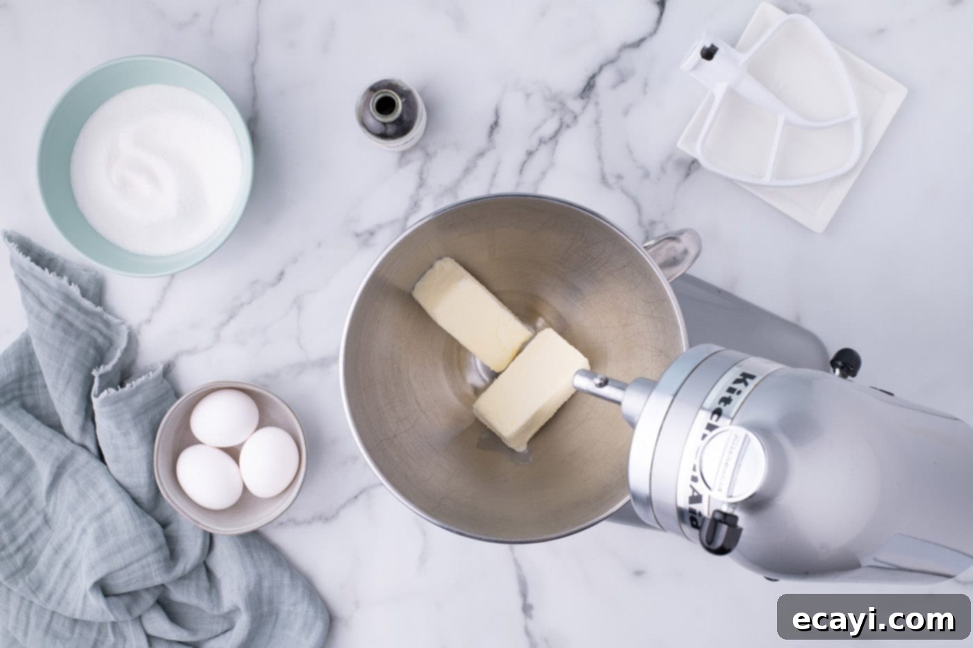 Decadent Red Velvet Treats 6 Beating softened butter in a stand mixer bowl to achieve a light and fluffy consistency for red velvet cupcake batter.