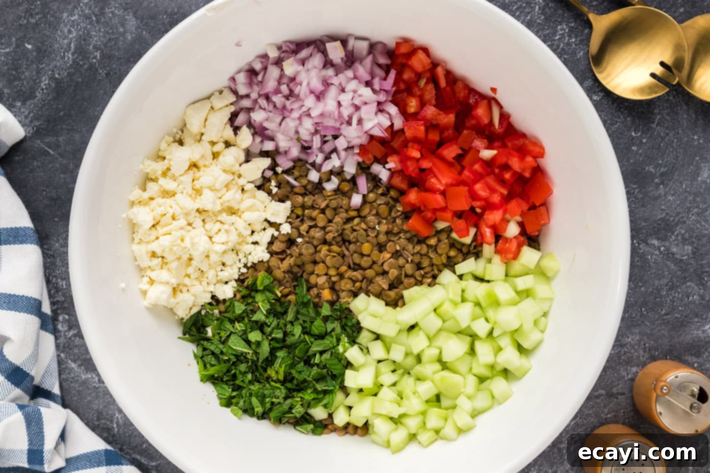 Zesty Lemon Herb Lentil Salad 7 lentils, roma tomatoes, shallots, cucumber, feta, and fresh mint in a bowl