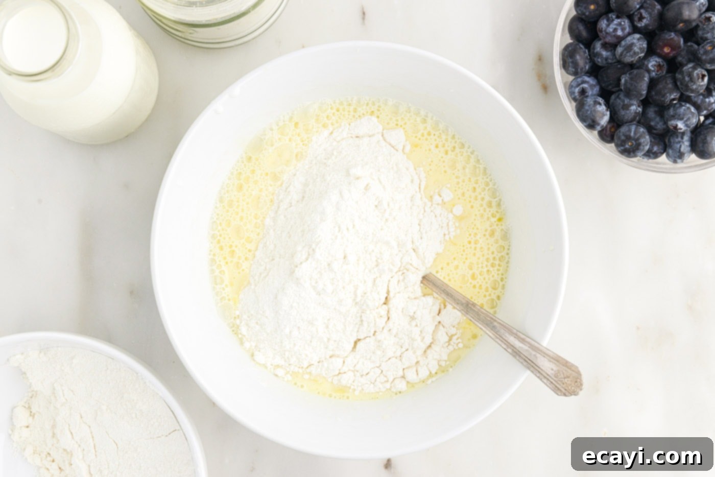 Bursting Blueberry Breakfast Flapjacks 7 whisking wet and dry ingredients together in a bowl