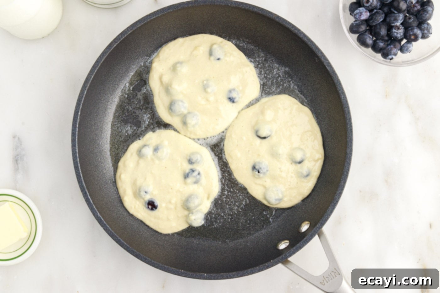 Bursting Blueberry Breakfast Flapjacks 10 fresh blueberry pancakes in a skillet