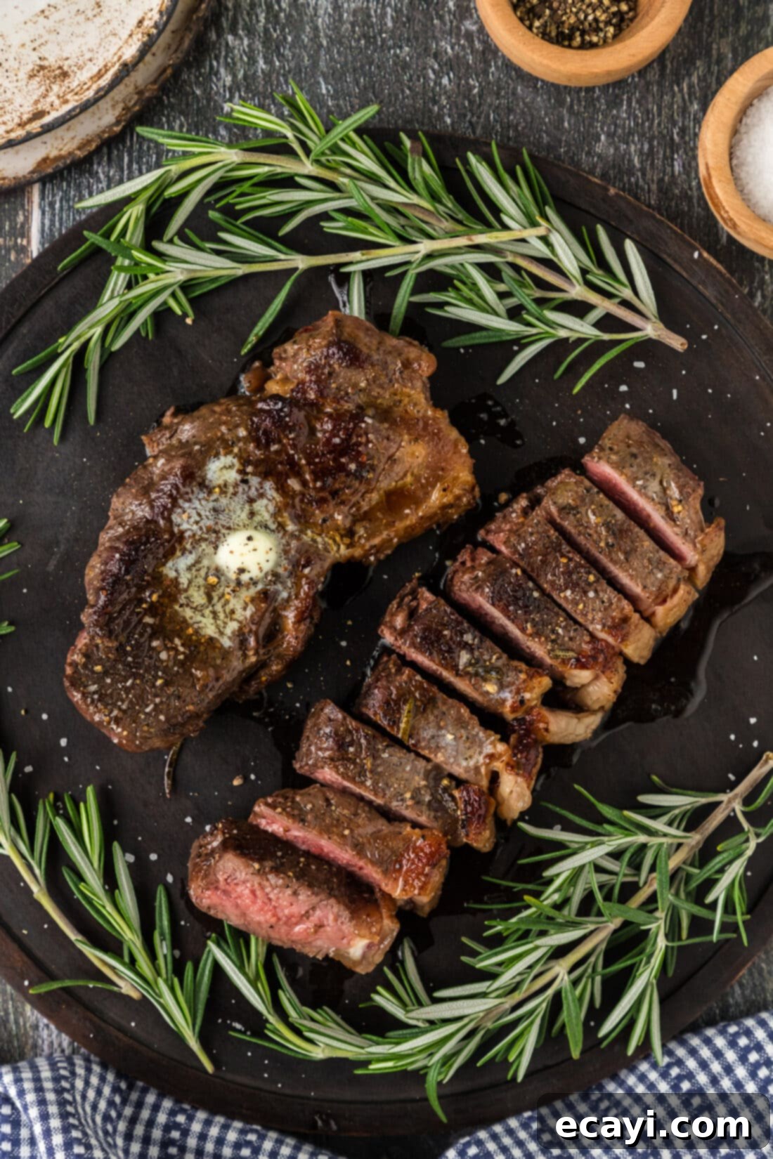 Perfect Sous Vide Steak 2 Two perfectly cooked sous vide steaks on a platter, one sliced to reveal a flawless medium-rare interior.