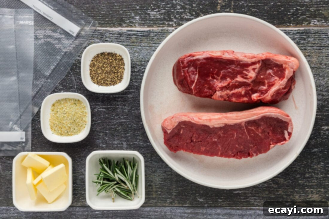 Perfect Sous Vide Steak 4 Arrangement of ingredients for sous vide steak: raw New York strip, fresh rosemary, butter, garlic salt, and black pepper.