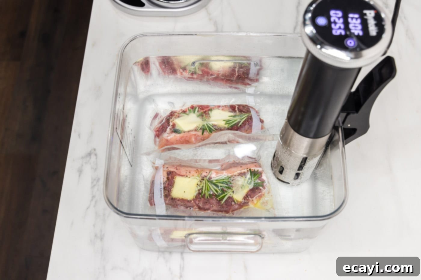 Perfect Sous Vide Steak 8 Vacuum-sealed New York strip steaks submerged and cooking in a sous vide water bath.