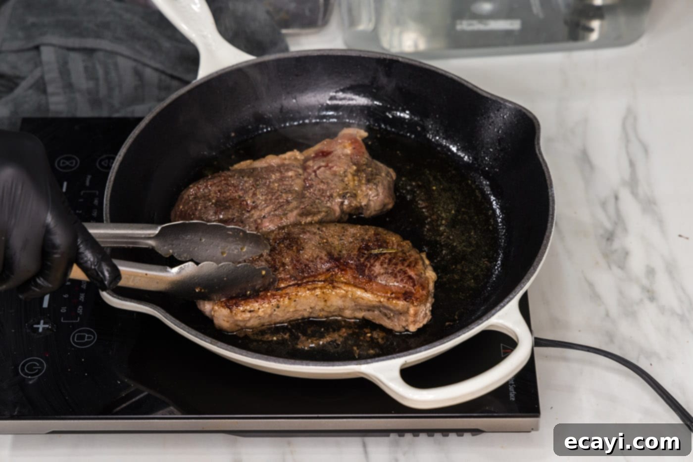 Perfect Sous Vide Steak 10 Two beautifully seared sous vide New York strip steaks resting after being removed from the skillet.