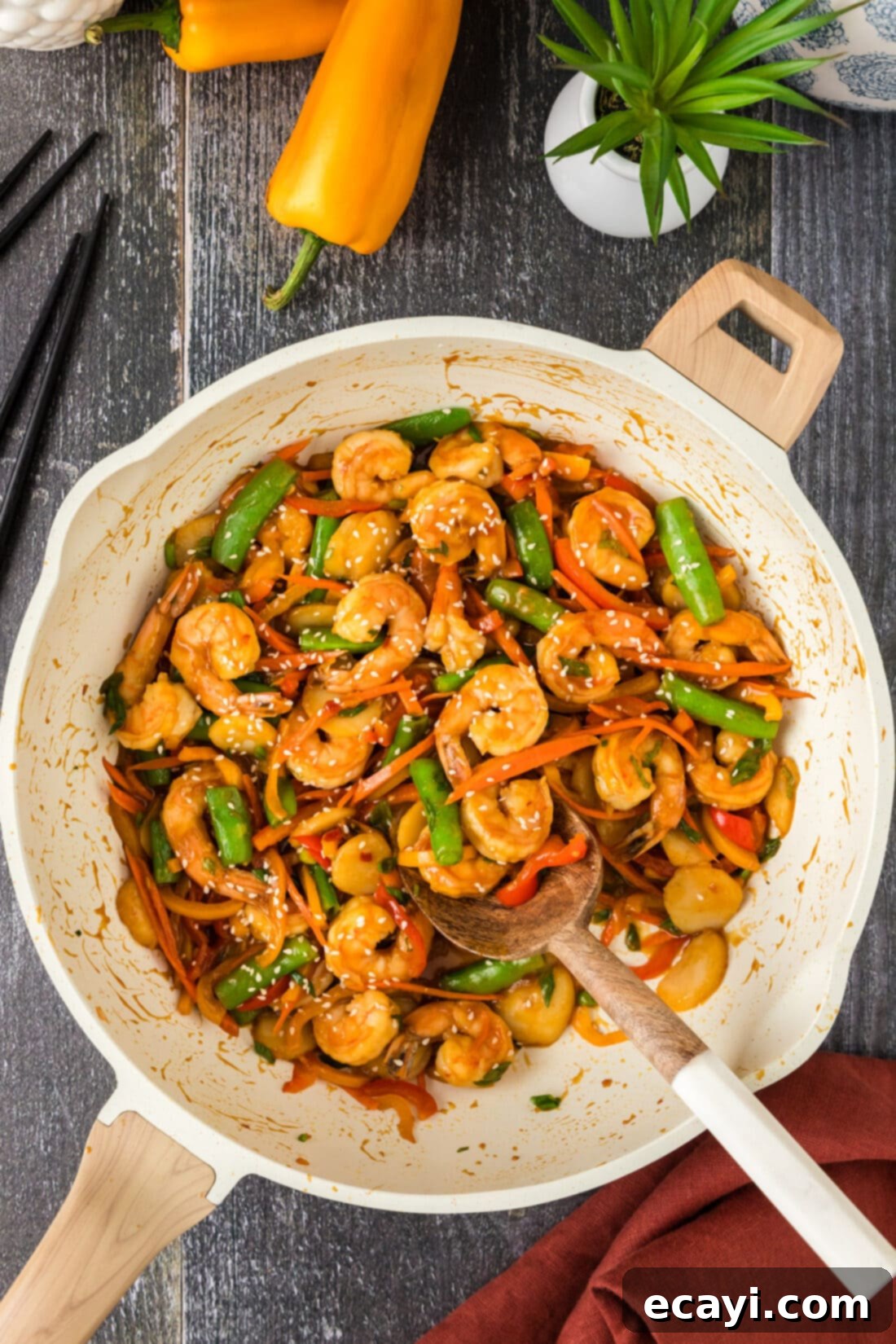 Quickfire Shrimp Stir-Fry 2 Shrimp Stir Fry in a skillet with a spoon, showcasing tender shrimp and colorful vegetables