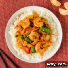 Quickfire Shrimp Stir-Fry 14 Shrimp Stir Fry over a bed of rice on a plate, garnished with green onions