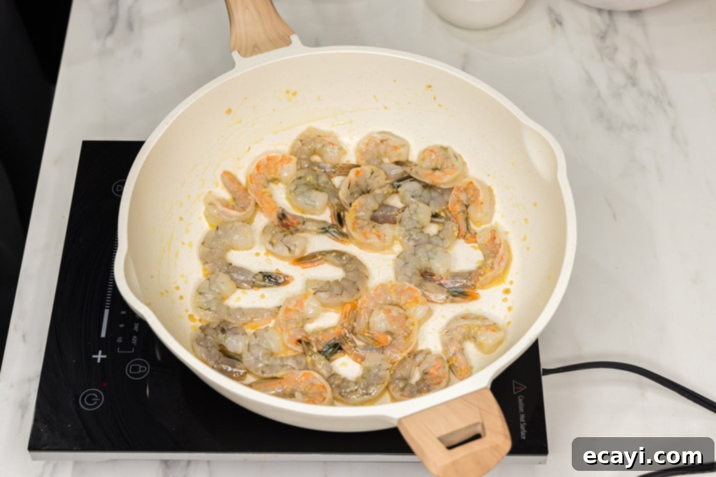Quickfire Shrimp Stir-Fry 5 shrimp in a skillet with oil and garlic, cooking to a pink color