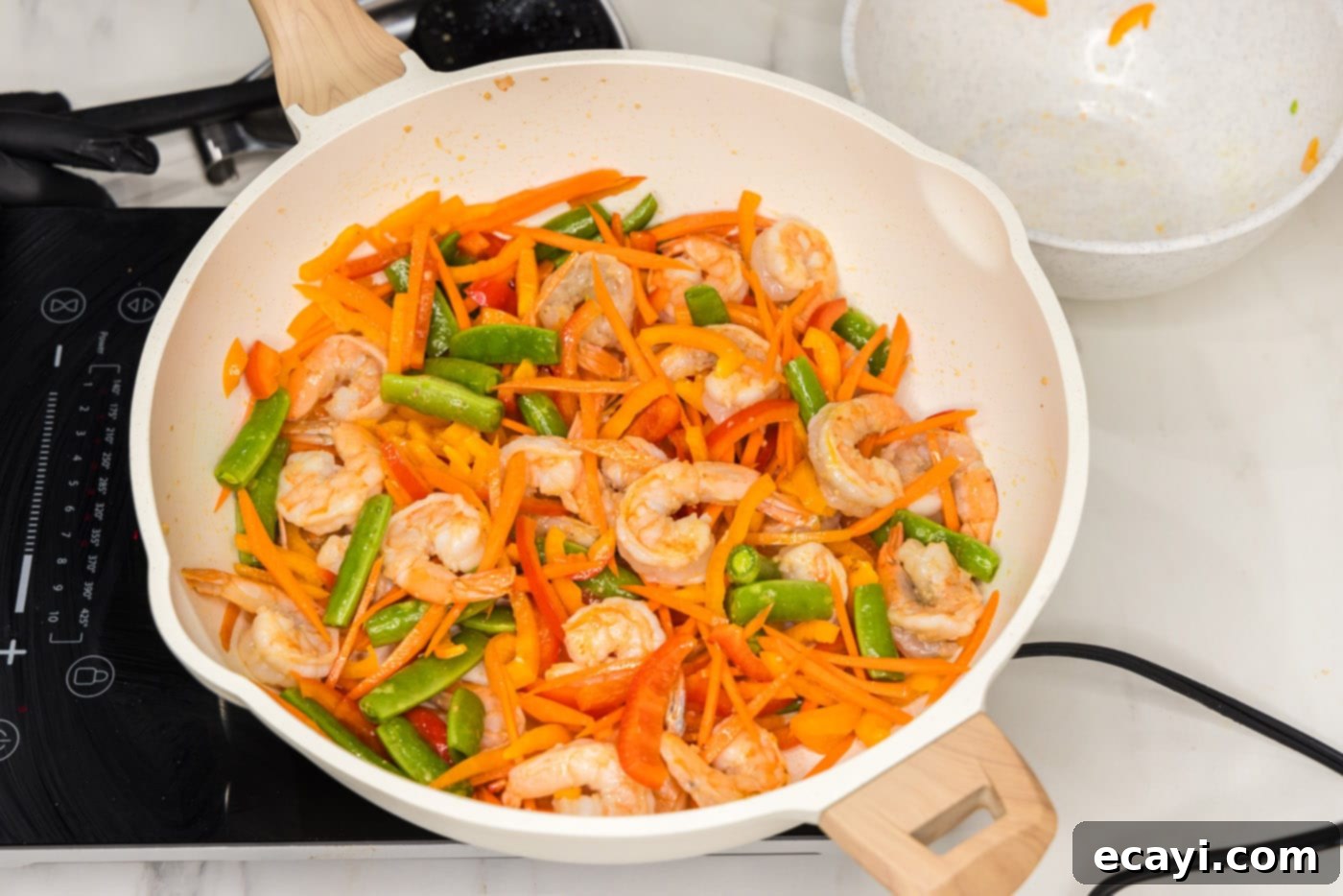 Quickfire Shrimp Stir-Fry 6 carrots, snap peas, and bell peppers added to skillet with shrimp, stir-frying together