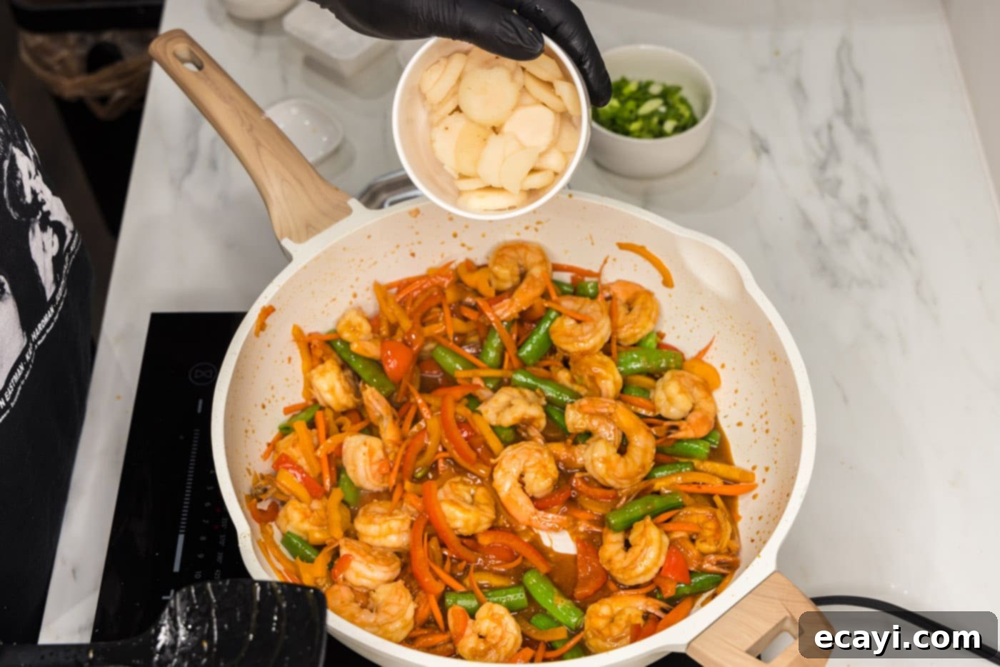 Quickfire Shrimp Stir-Fry 10 adding water chestnuts to skillet with shrimp and veggies for extra crunch