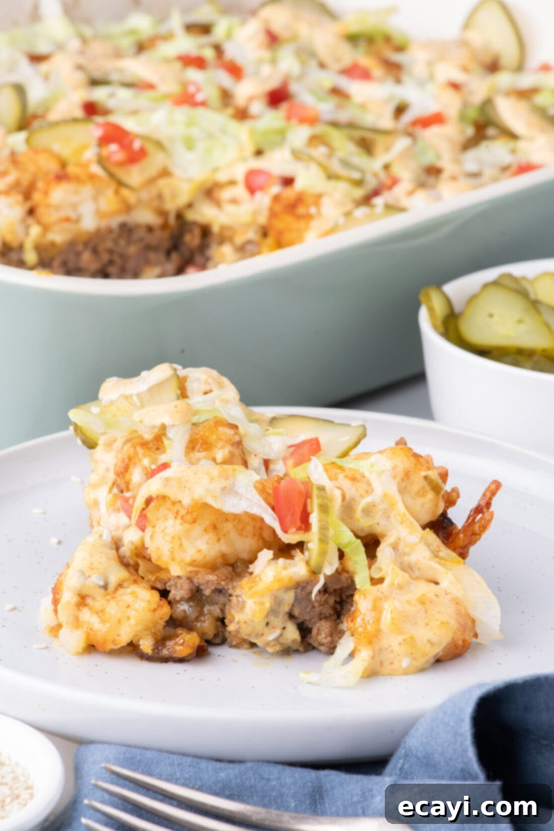 Special Sauce Cheeseburger Casserole 2 Big Mac Casserole on a plate, showing layers of beef, cheese, tater tots, sauce, and toppings