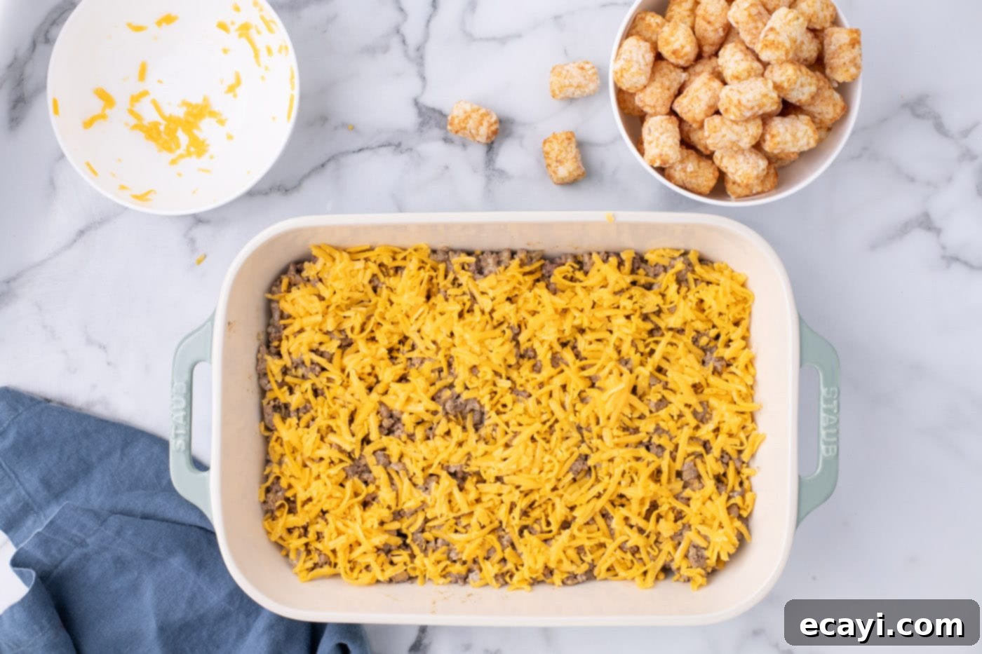Special Sauce Cheeseburger Casserole 11 shredded cheese on top of ground beef in casserole dish