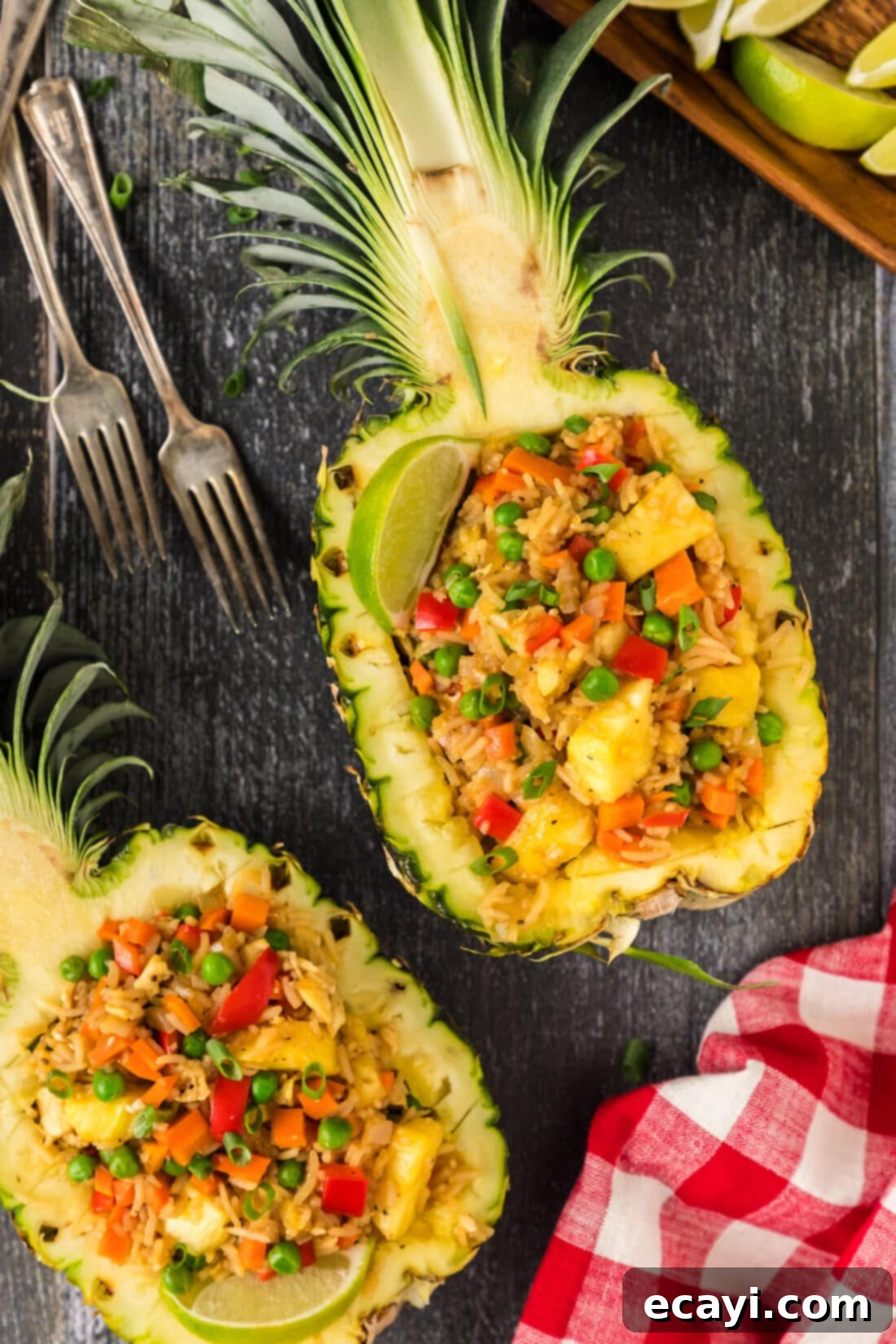 Sun-Kissed Pineapple Rice 2 Tropical Pineapple Fried Rice served in a carved pineapple bowl, garnished with fresh cilantro, showcasing golden rice, vibrant peas, and juicy pineapple chunks.