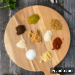 Signature Pulled Pork Blend 8 Ingredients for Pulled Pork Rub neatly arranged on a rustic wooden platter.