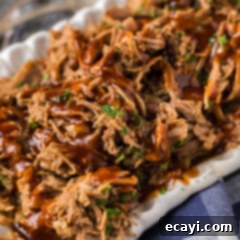 Slow-Cooked Shredded Pork 6 Close up photo of Pulled Pork with barbecue sauce drizzled on top