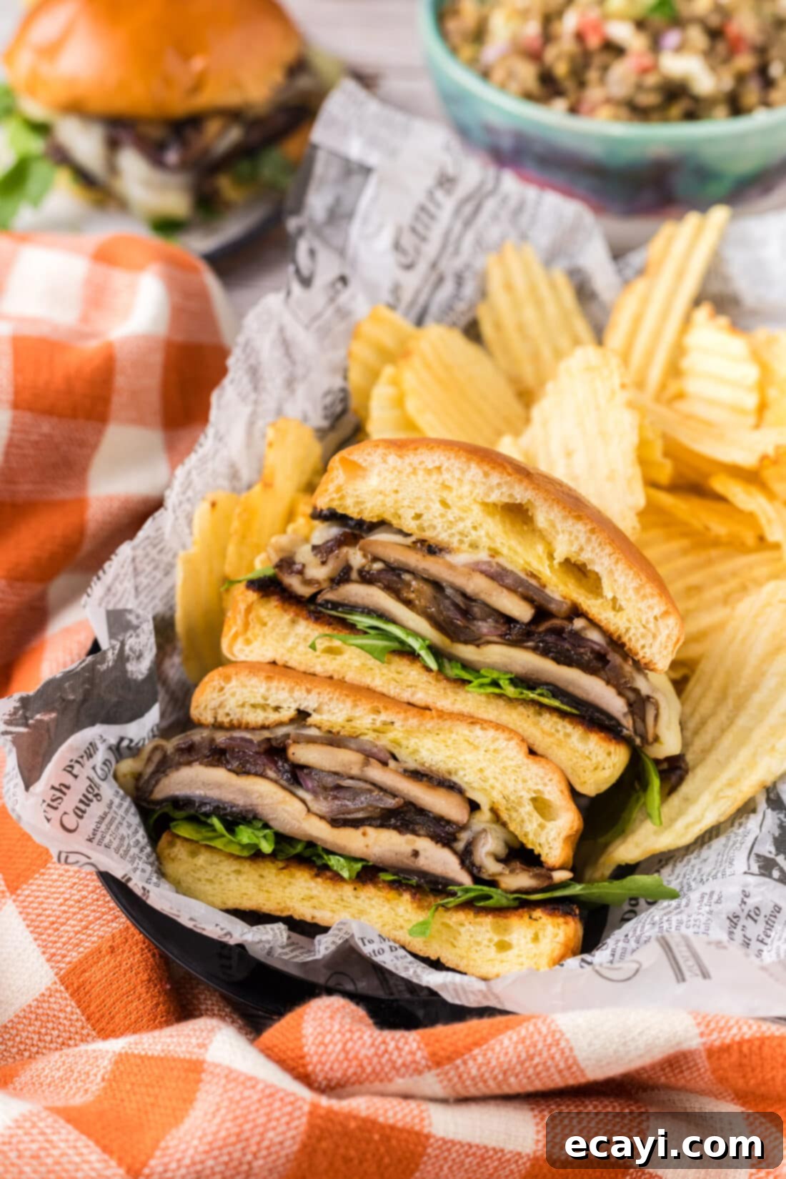 Mushroom Burger 2 Mushroom Burger cut in half in a basket with chips