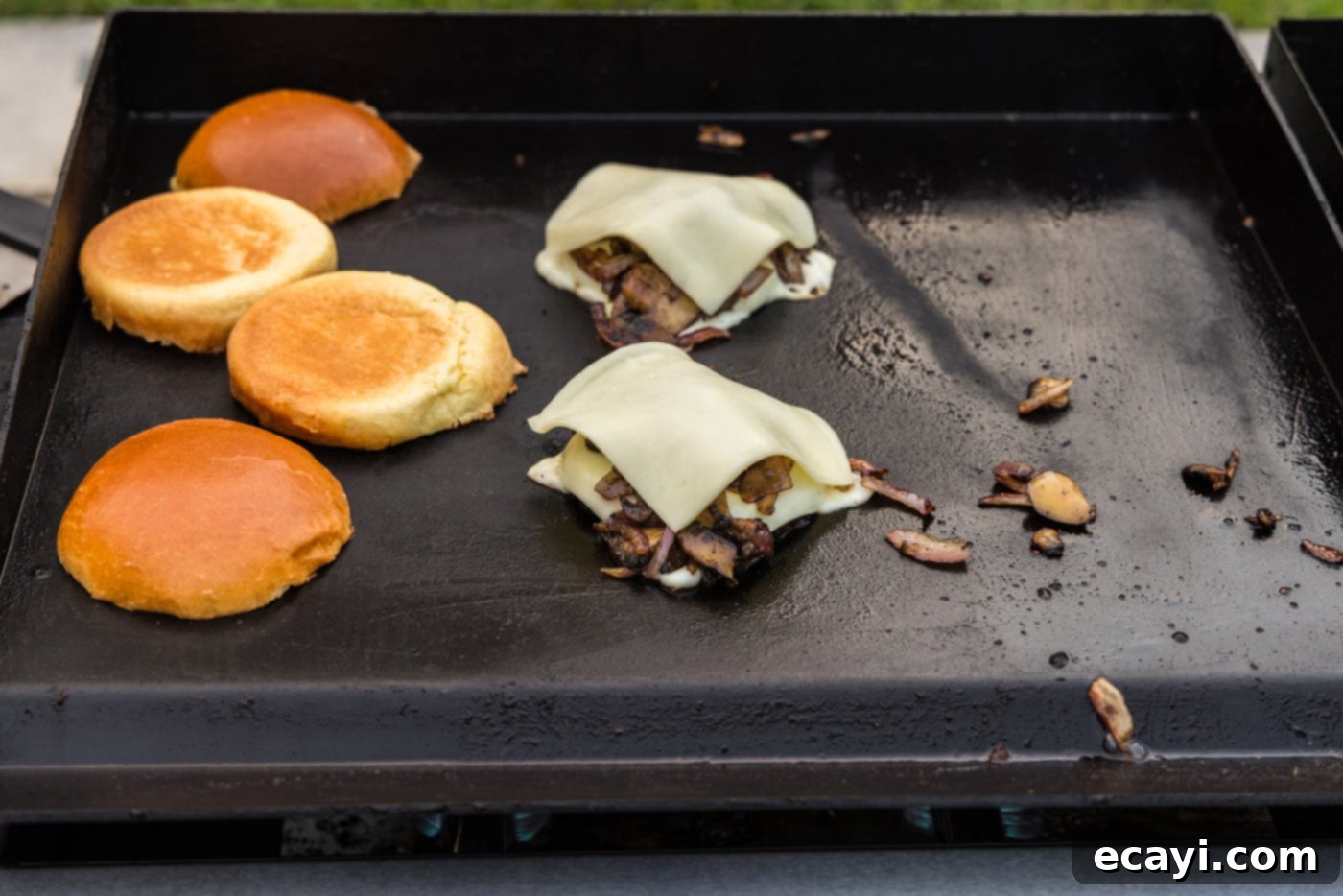 Mushroom Burger 15 sliced mozzarella cheese on top of mushroom burgers on the grill