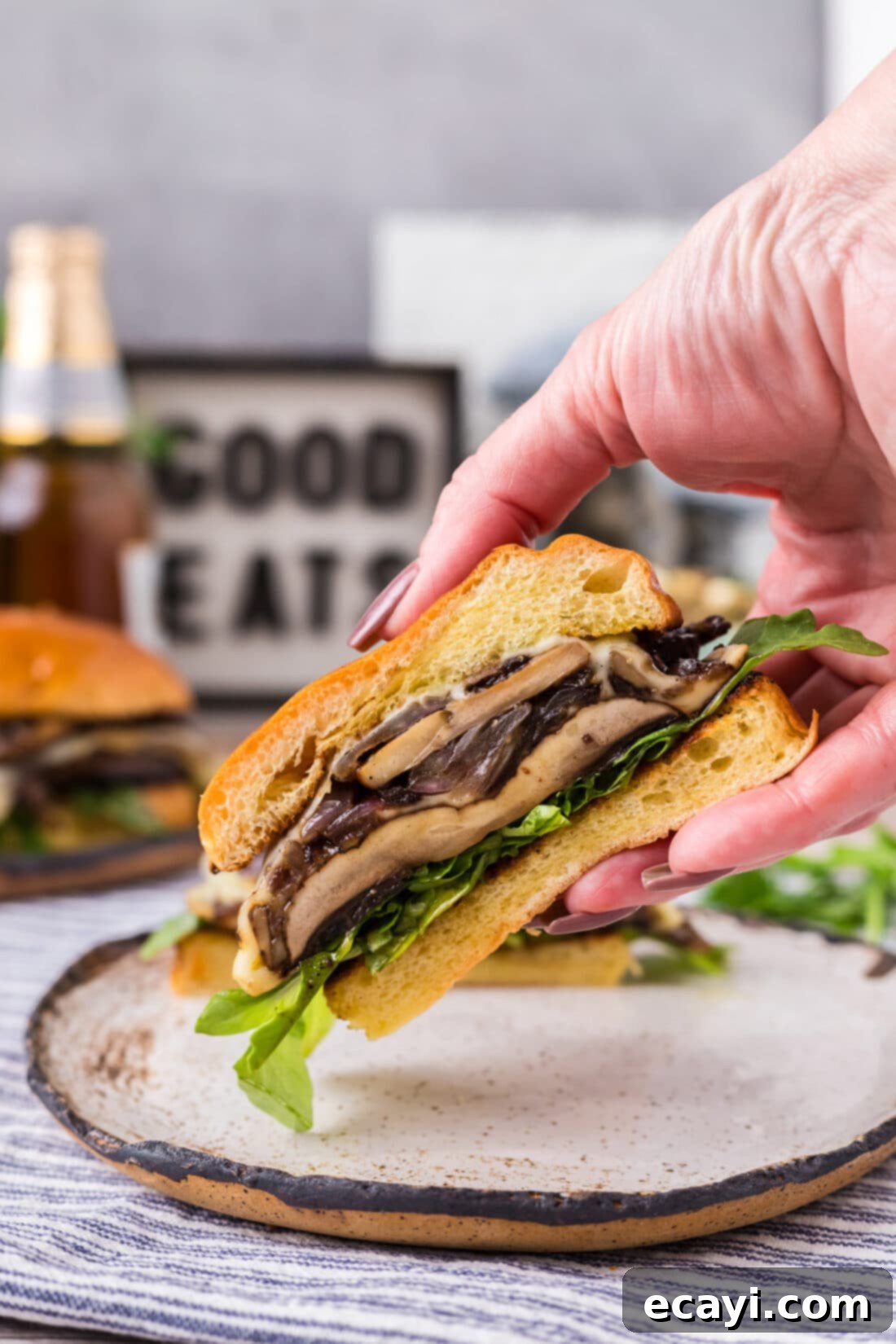 Mushroom Burger 3 Hand holding up half of a Mushroom Burger