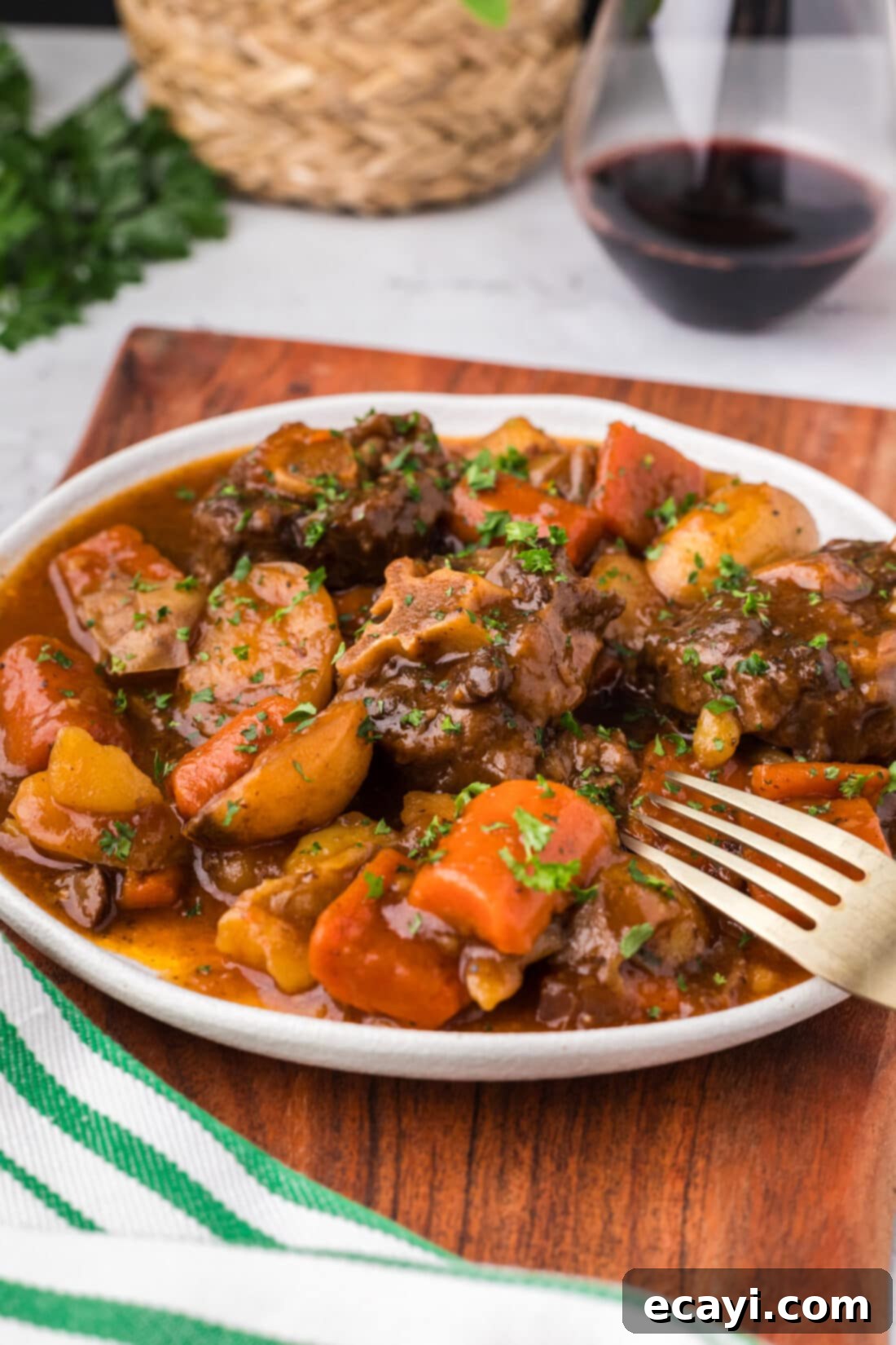 Instant Pot Fall-Off-The-Bone Oxtail 2 Close up photo of a plate of Instant Pot Oxtail with a fork on it