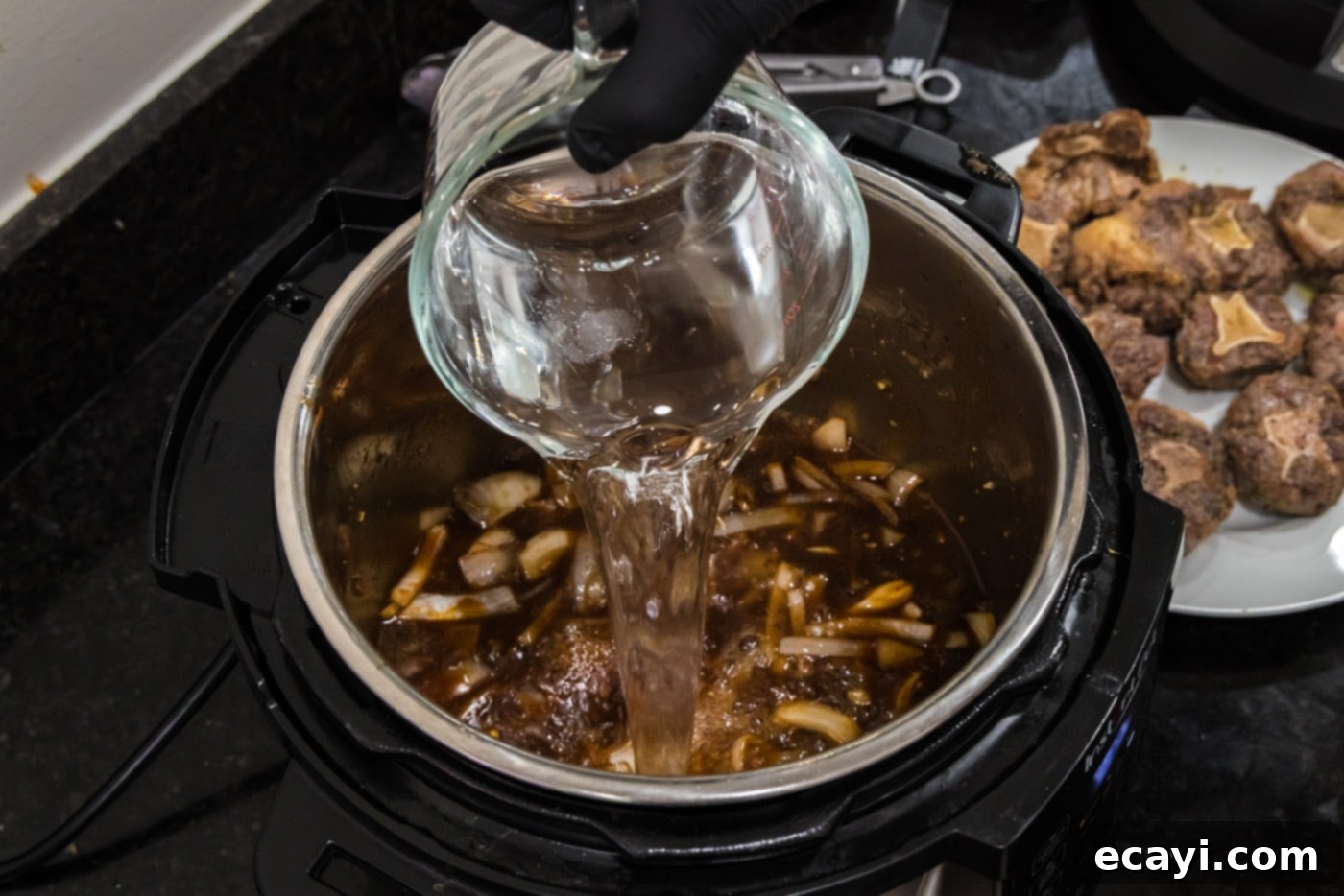Instant Pot Fall-Off-The-Bone Oxtail 8 pouring water into instant pot oxtail stew