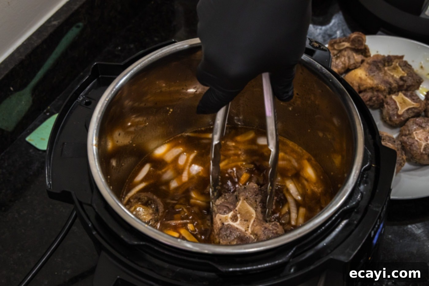 Instant Pot Fall-Off-The-Bone Oxtail 9 adding oxtail to sauce mixture in instant pot