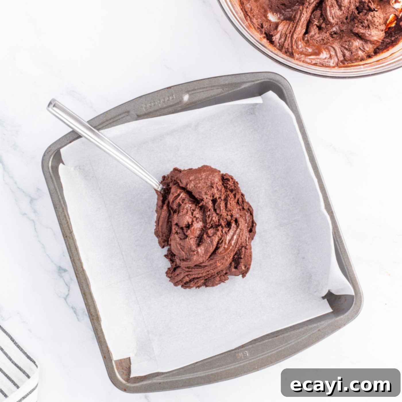 Irresistible Andes Mint Fudge 6 spreading chocolate fudge mixture in a baking pan