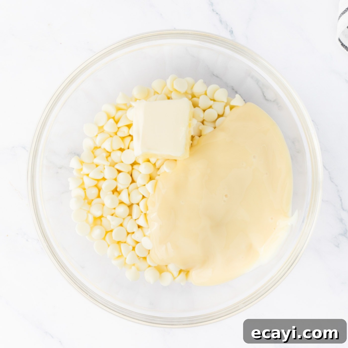 Irresistible Andes Mint Fudge 7 white chocolate chips in a bowl with sweetened condensed milk and butter