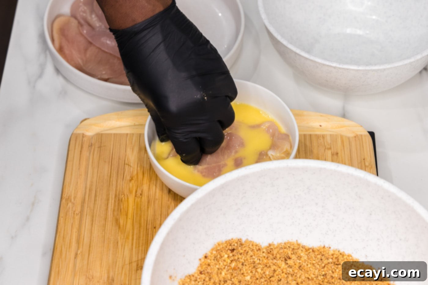 Golden Almond Chicken 8 dipping chicken breast into egg