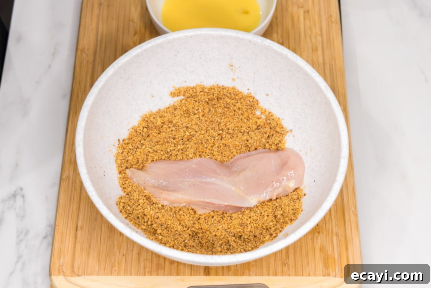 Golden Almond Chicken 9 dredging chicken breast in crushed almonds