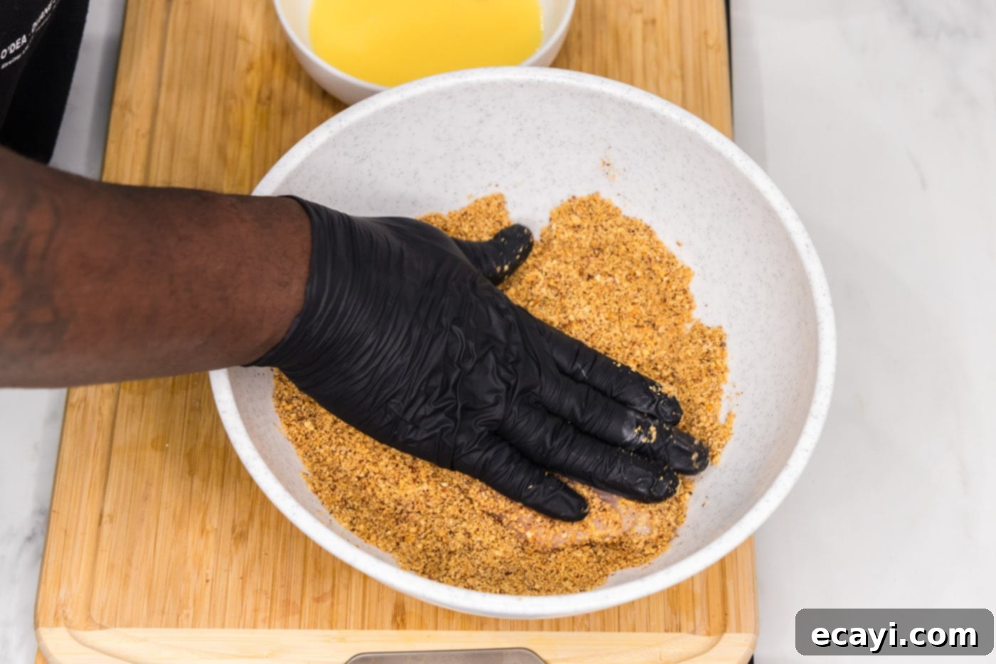 Golden Almond Chicken 10 hand patting chicken breast with almond breading