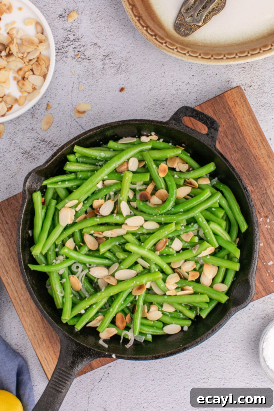 Almond-Kissed Crisp Green Beans 2 Green Beans Almondine in a skillet, showcasing a vibrant and delicious side dish with crisp beans and golden almonds.