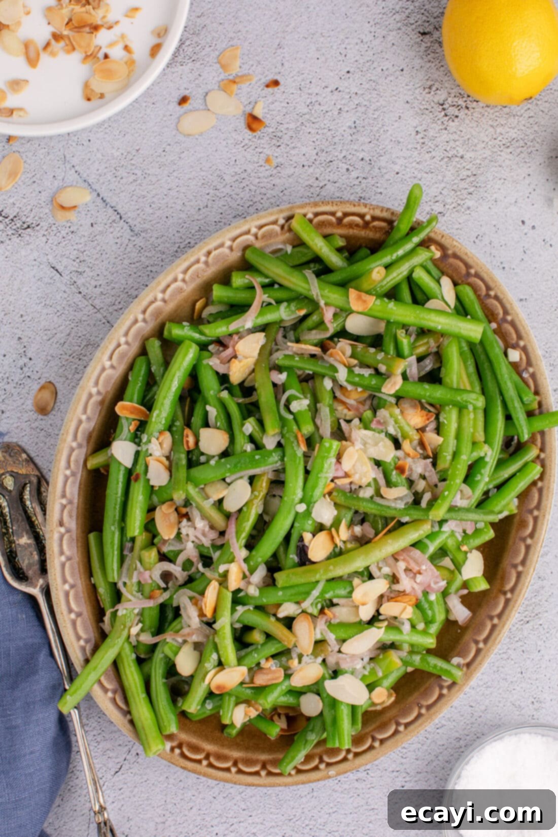 Almond-Kissed Crisp Green Beans 13 Green Beans Almondine served in an elegant serving platter, ready to be enjoyed as a gourmet side dish.