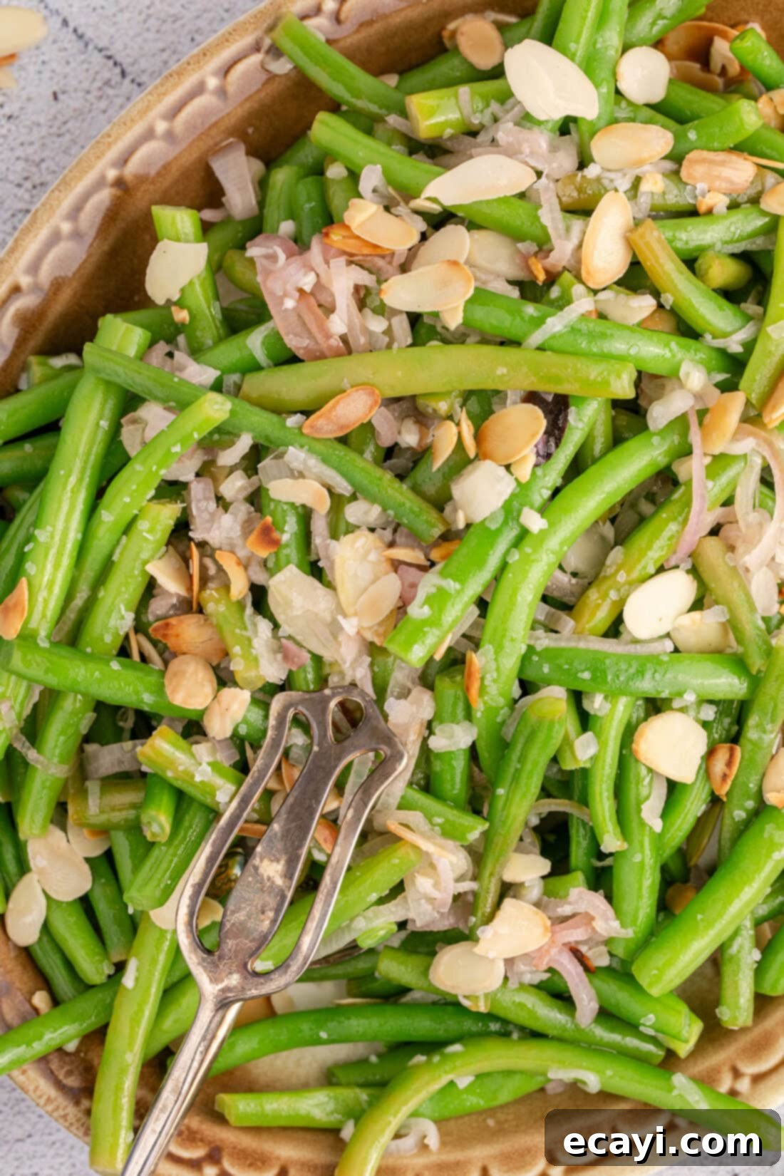 Almond-Kissed Crisp Green Beans 3 Close up photo of Green Beans Almondine, showing the golden toasted almonds mixed with vibrant green beans and hints of butter.