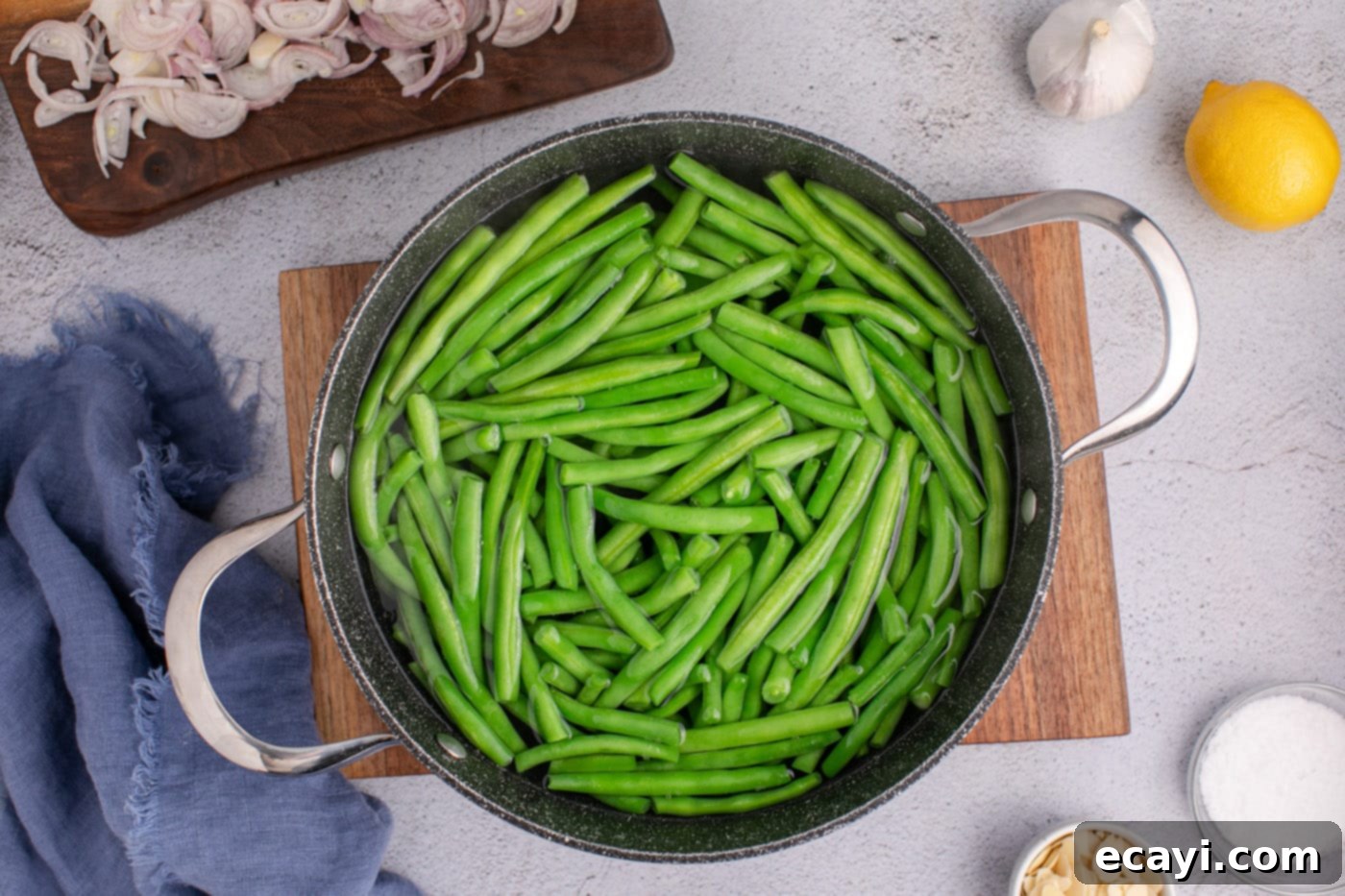 Almond-Kissed Crisp Green Beans 5 Blanching fresh green beans in a large stockpot of boiling water, showing the vibrant green color developing.