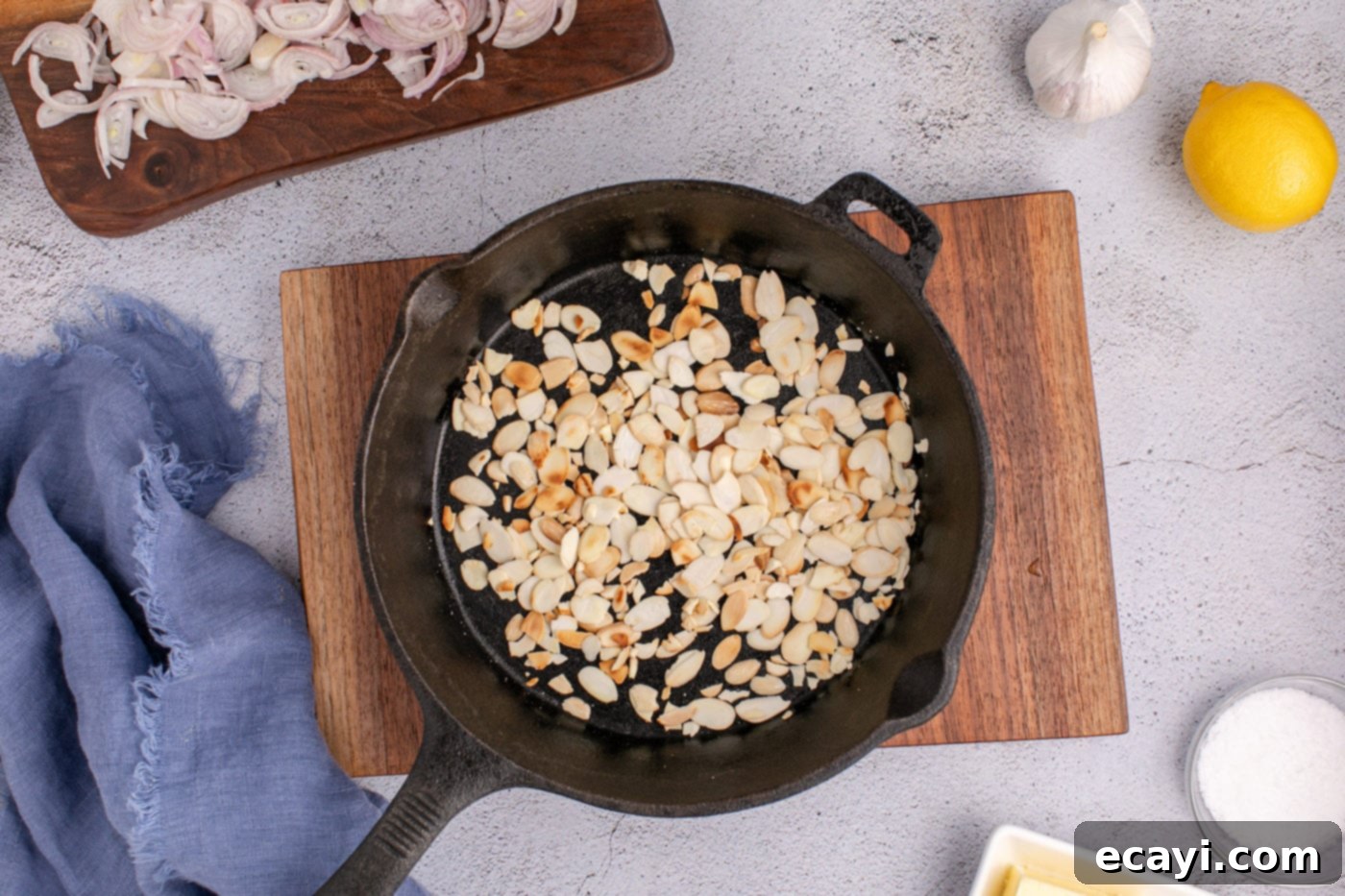 Almond-Kissed Crisp Green Beans 7 Toasting sliced almonds in a cast iron skillet over medium-low heat until lightly golden and fragrant.