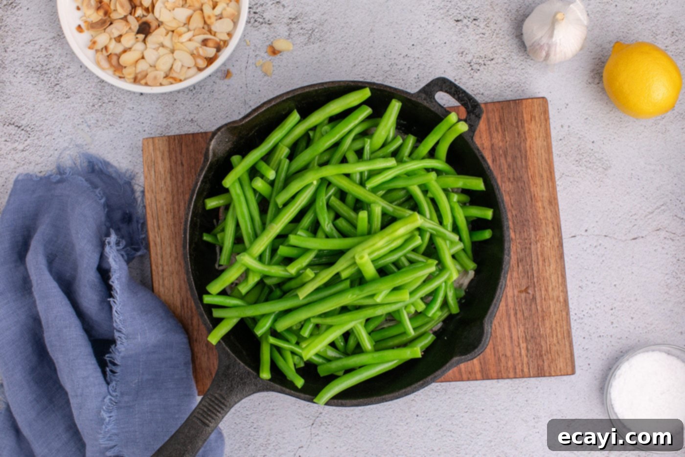 Almond-Kissed Crisp Green Beans 10 Adding blanched green beans to the skillet with sautéed shallots and butter, ready to be mixed.