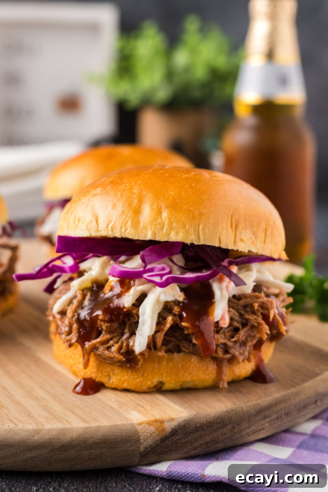 Smoky BBQ Pulled Pork Sandwiches 2 Pulled Pork Sandwich on a wooden board