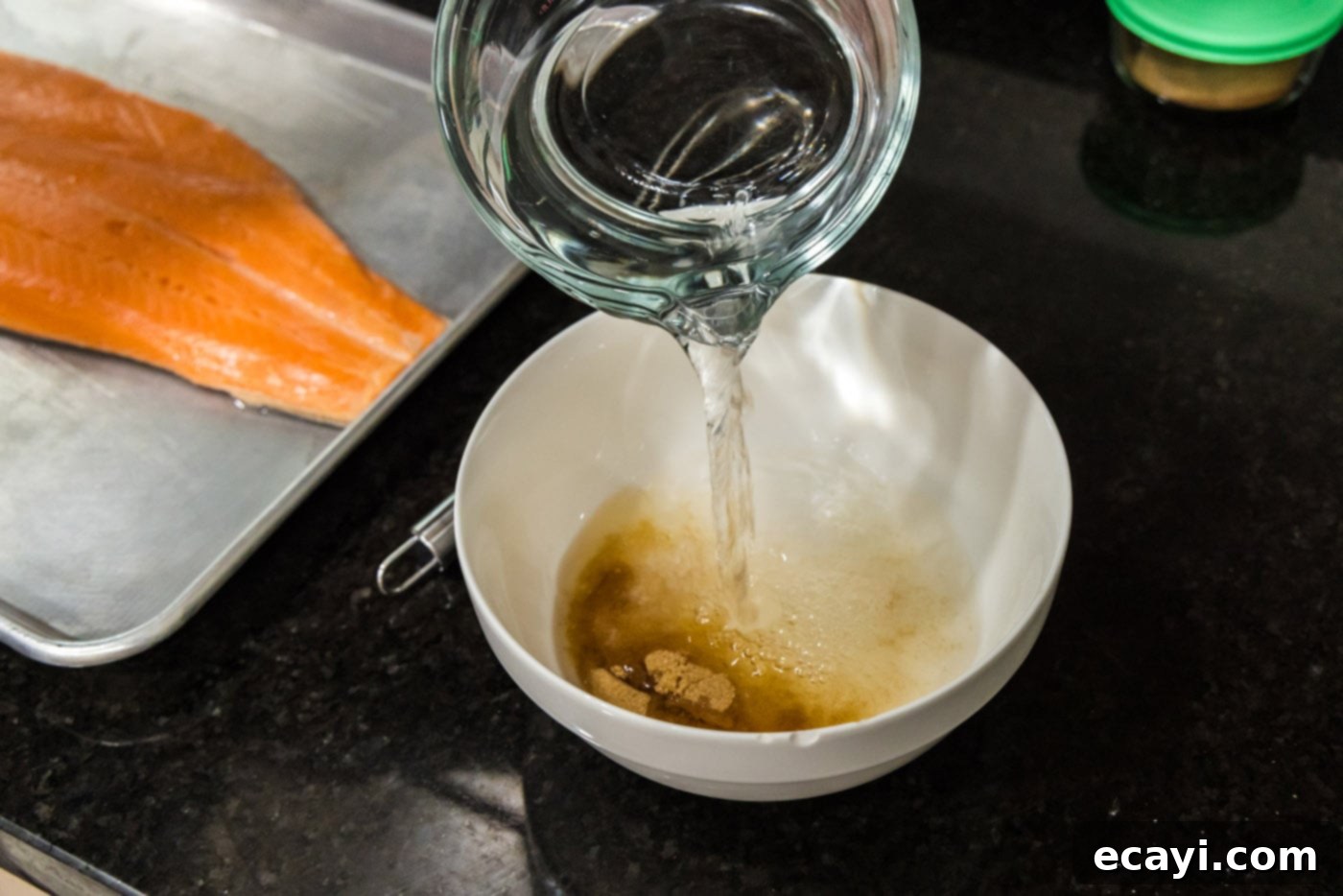 Artisan Smoked Trout 5 Pouring water over brown sugar and salt in a bowl to create the brine.