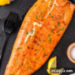 Artisan Smoked Trout 10 Smoked Trout on a board with lemons and a fork to the side