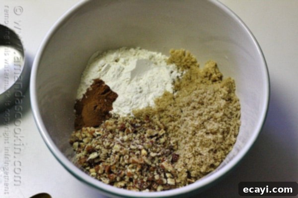 Cozy Pumpkin Mini Cakes with Cinnamon Streusel 12 A mixing bowl of chopped pecans, packed brown sugar, unbleached all purpose flour and ground cinnamon.