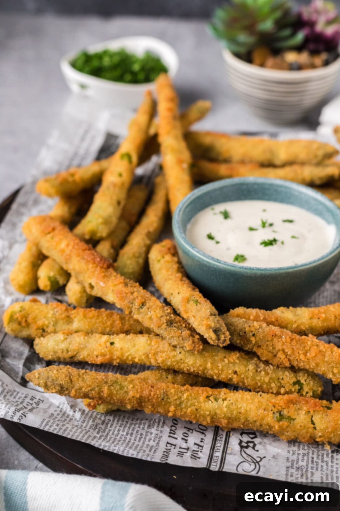Golden Asparagus Crunch 3 Fried Asparagus on a plate with ranch for dipping in a bowl